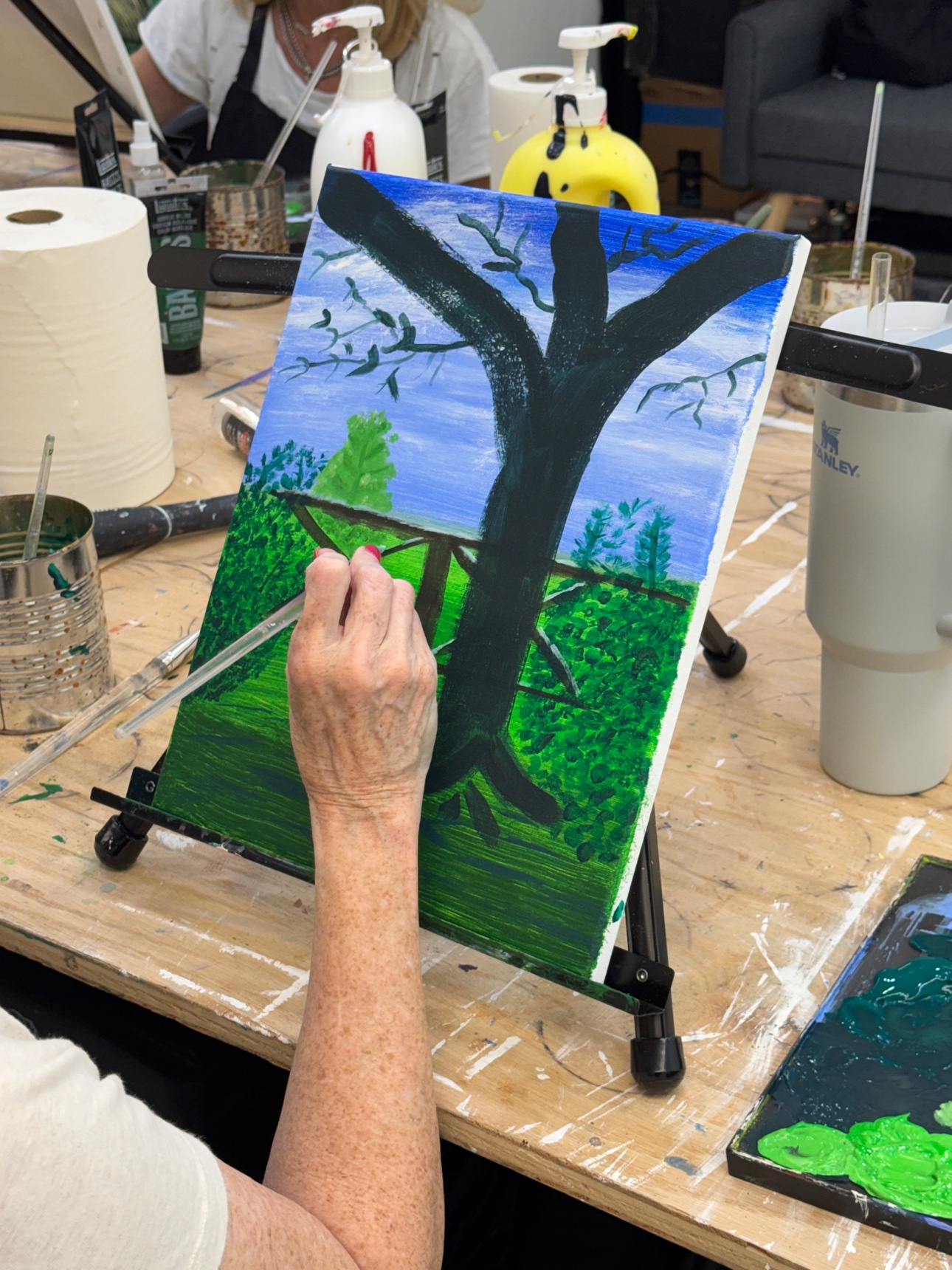 Working on an acrylic painting during an evening class at the Richardson studio.