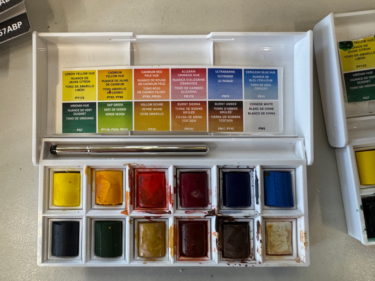 A watercolor pan set with twelve colors. The whole kit fits in one small box.