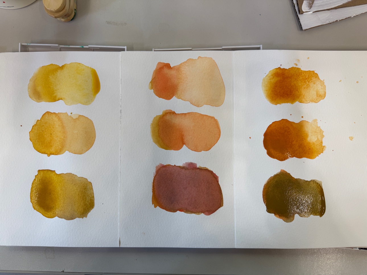 Testing watercolor mixes on paper before they go into a painting.